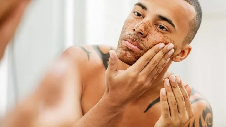 man rubbing cream on beard